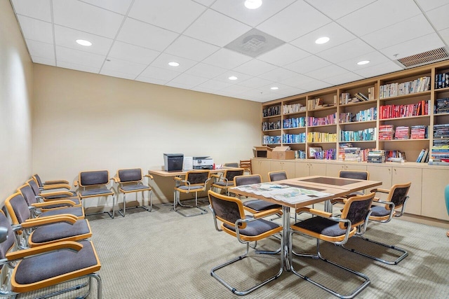 carpeted office space with built in shelves, visible vents, and recessed lighting