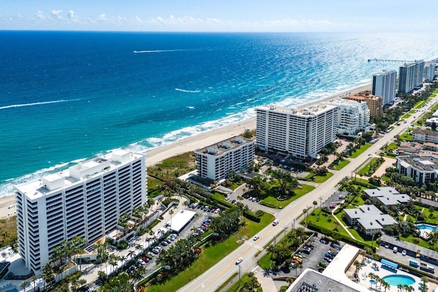 aerial view with a water view, a beach view, and a city view