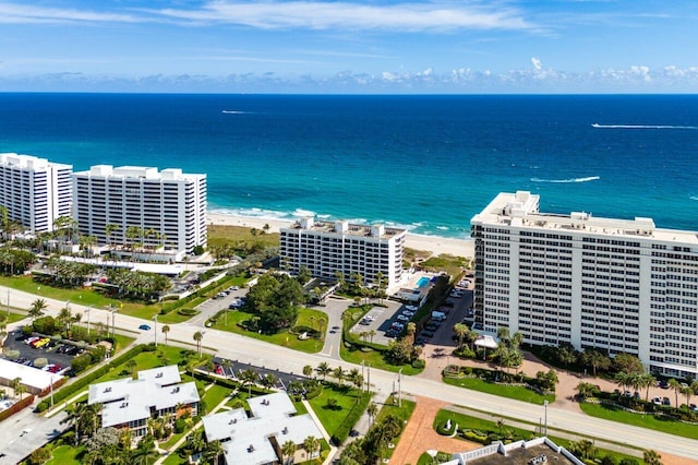 drone / aerial view with a view of city, a water view, and a beach view