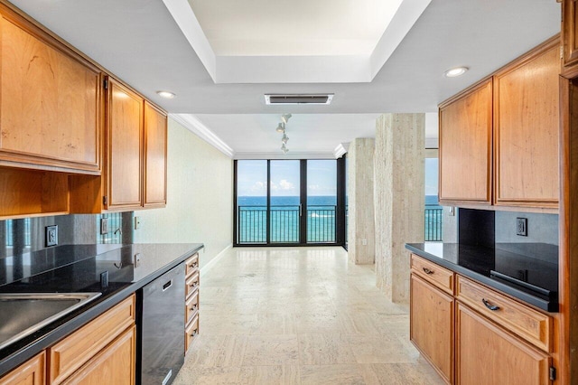 kitchen with dark countertops, a water view, black dishwasher, and visible vents