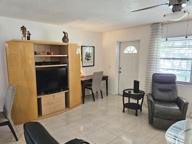 tiled living room featuring a textured ceiling and ceiling fan