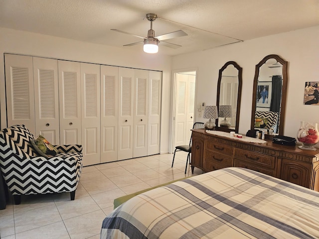 tiled bedroom featuring ceiling fan and a textured ceiling