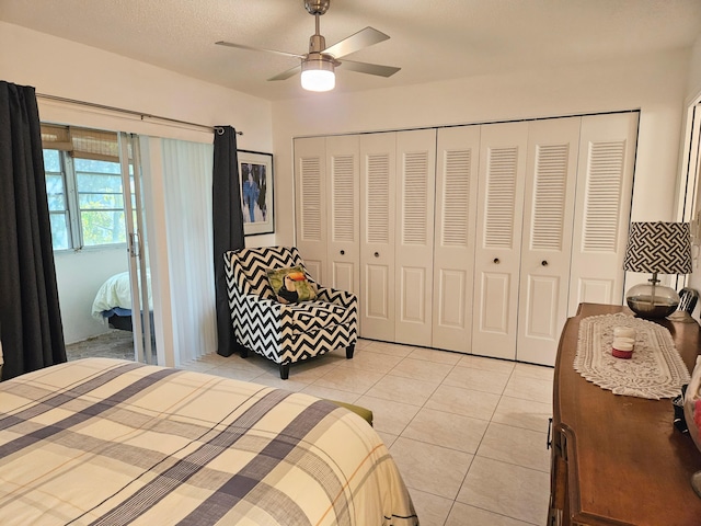 bedroom featuring light tile patterned floors, a textured ceiling, a closet, and ceiling fan