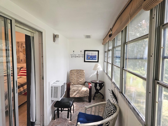 sunroom / solarium with a wall mounted air conditioner