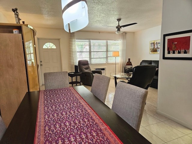 dining room featuring ceiling fan, a wall unit AC, light tile patterned floors, and a textured ceiling