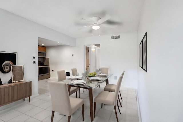 tiled dining space with ceiling fan