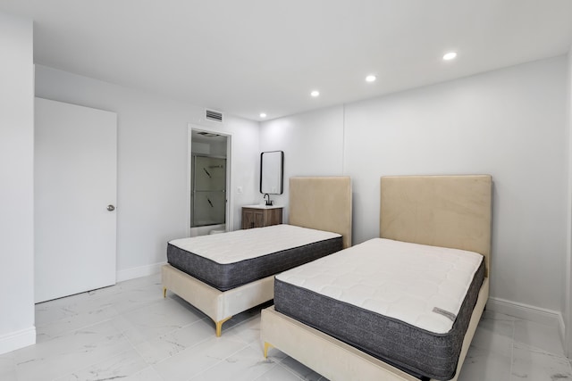 304 Wellington F, West Palm Beach, FL 33417 - bedroom featuring light marble finish flooring, baseboards, recessed lighting, and connected bathroom