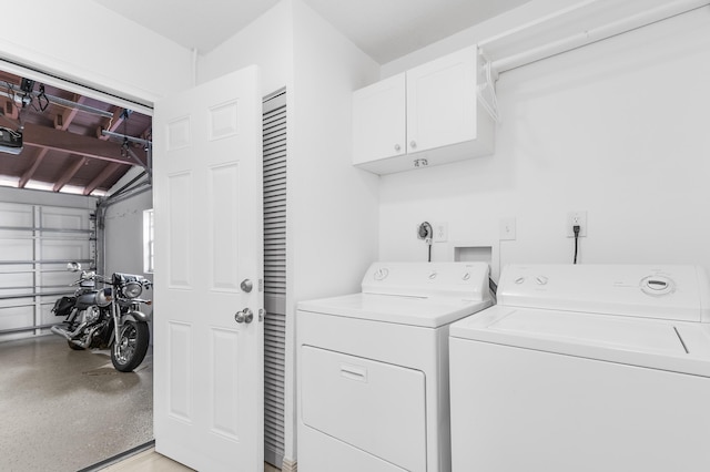 washroom featuring cabinets and separate washer and dryer