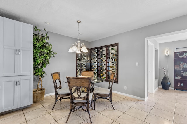 tiled dining area with an inviting chandelier