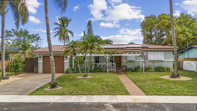 ranch-style house featuring a garage and a front yard