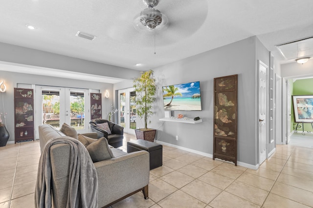 living room with ceiling fan, french doors, a textured ceiling, and light tile patterned floors