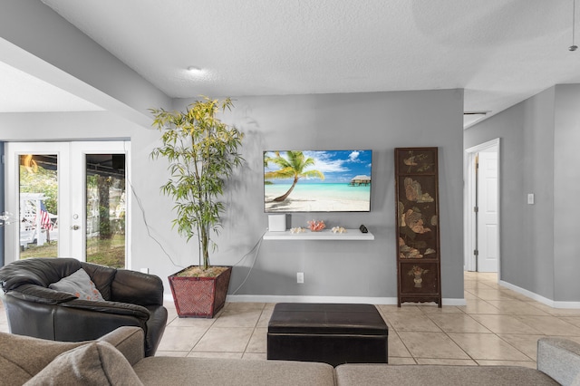 tiled living room featuring french doors and a textured ceiling