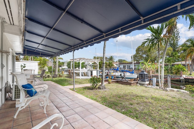 view of patio / terrace featuring a water view and a dock