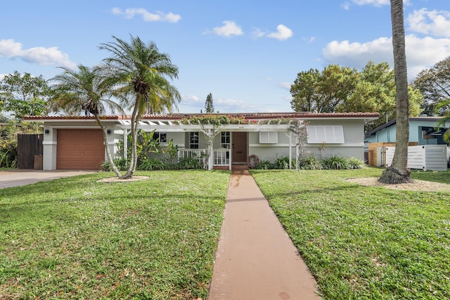 ranch-style house with a garage, covered porch, and a front yard