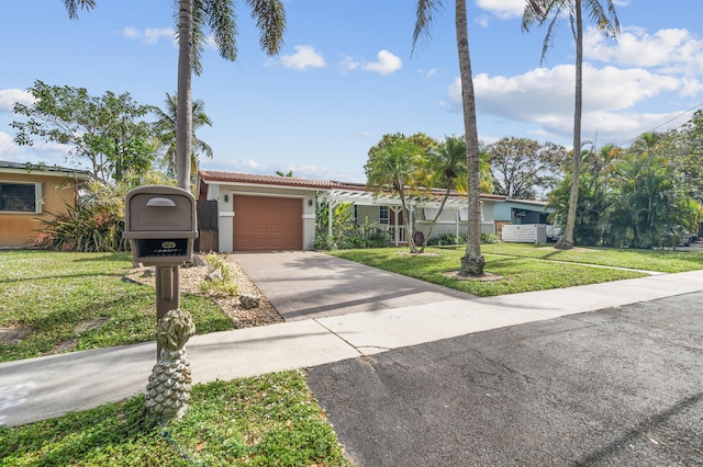 single story home with a garage and a front yard