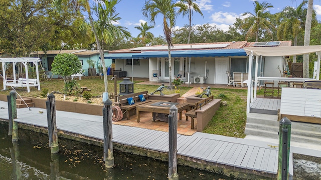 dock area with a water view and a lawn