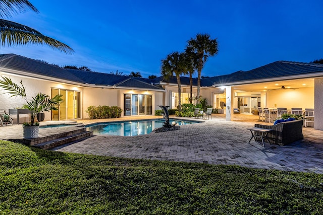 view of swimming pool with a patio, ceiling fan, and an in ground hot tub