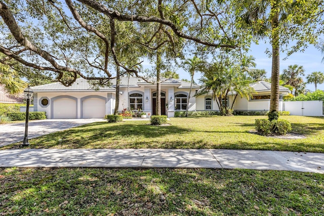 view of front of house with a garage and a front lawn