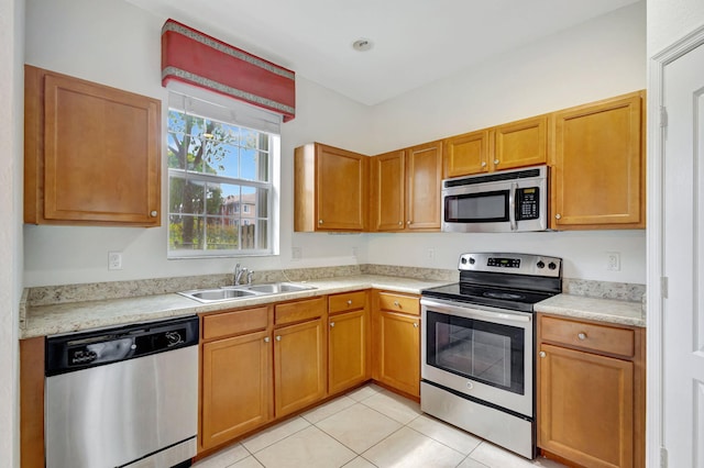 kitchen featuring appliances with stainless steel finishes, sink, and light tile patterned floors