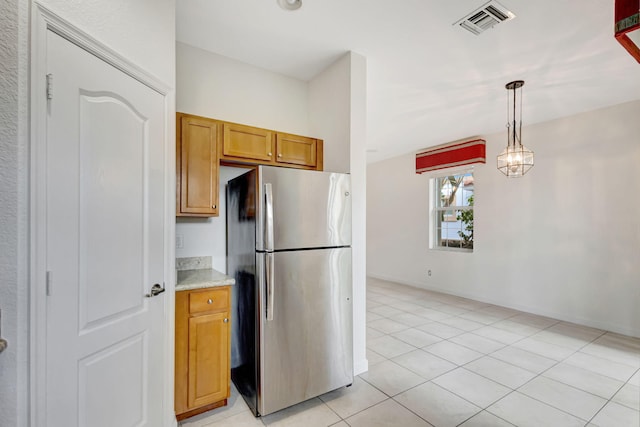 kitchen with pendant lighting, stainless steel fridge, and light tile patterned floors