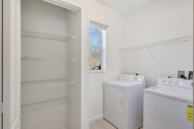 washroom with washing machine and clothes dryer and light tile patterned flooring