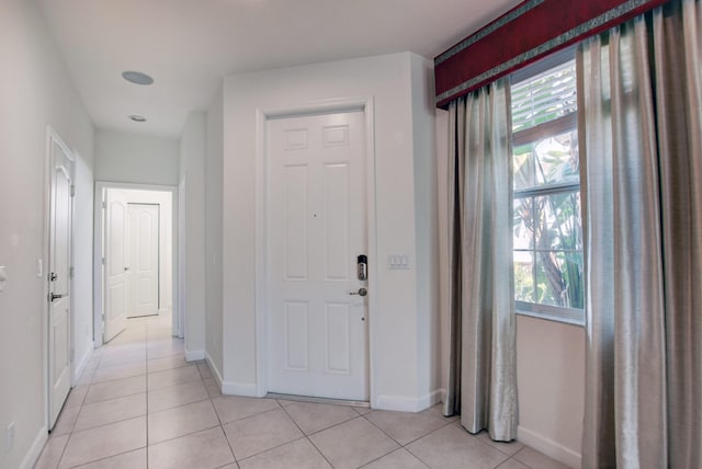 tiled foyer with a healthy amount of sunlight