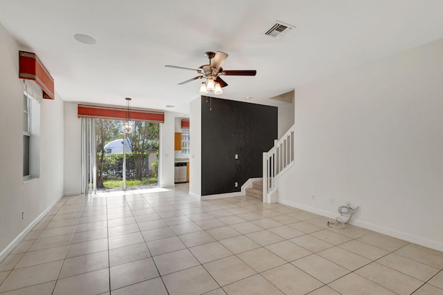 empty room with light tile patterned floors and ceiling fan