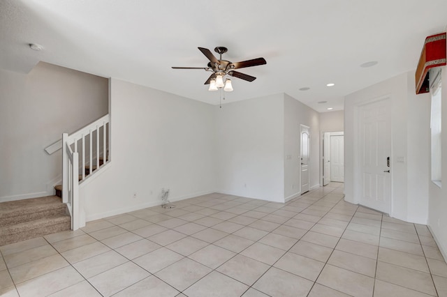 tiled empty room featuring ceiling fan