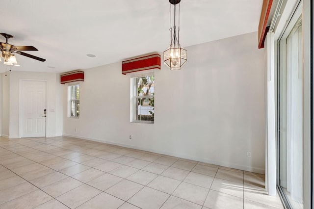 spare room featuring light tile patterned floors and ceiling fan