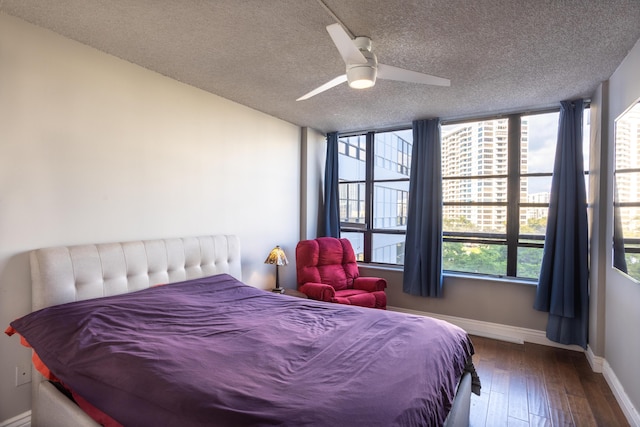 bedroom with hardwood / wood-style flooring, ceiling fan, and a textured ceiling