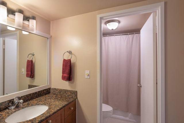 bathroom featuring vanity, curtained shower, and toilet