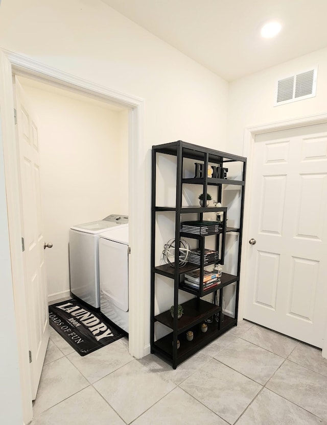 laundry room featuring independent washer and dryer and light tile patterned floors