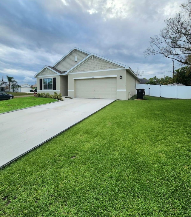 view of front of property featuring a garage and a front yard