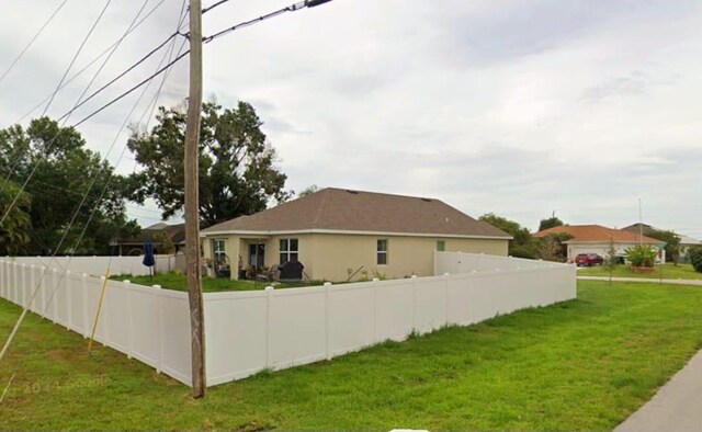 view of property exterior with a lawn