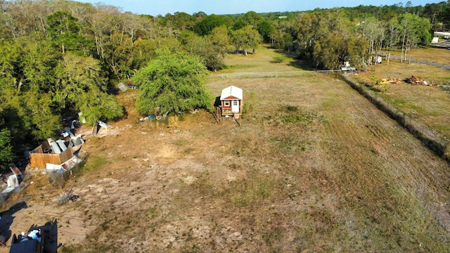 birds eye view of property with a rural view and a wooded view