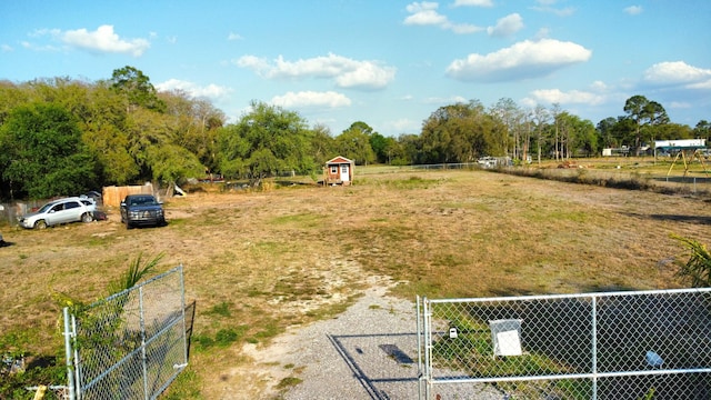 view of yard with a rural view and fence