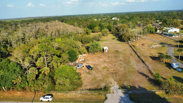 birds eye view of property with a wooded view