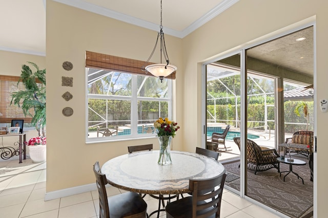 dining space featuring a sunroom, light tile patterned flooring, crown molding, and baseboards