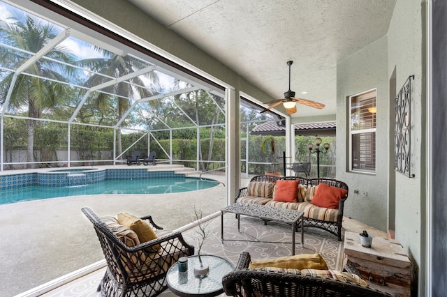 view of swimming pool with a patio, glass enclosure, and a ceiling fan