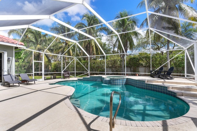 view of swimming pool with glass enclosure, a patio area, and a pool with connected hot tub