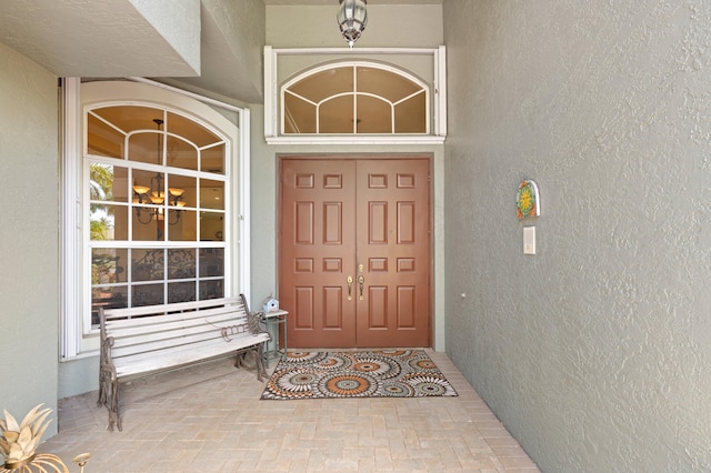 doorway to property featuring stucco siding