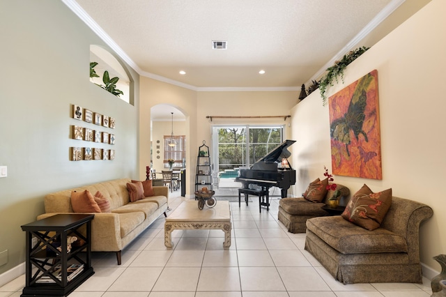 living room featuring arched walkways, ornamental molding, light tile patterned floors, and visible vents