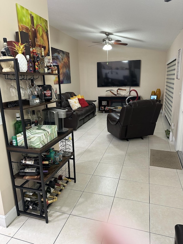 tiled living room featuring baseboards and a ceiling fan