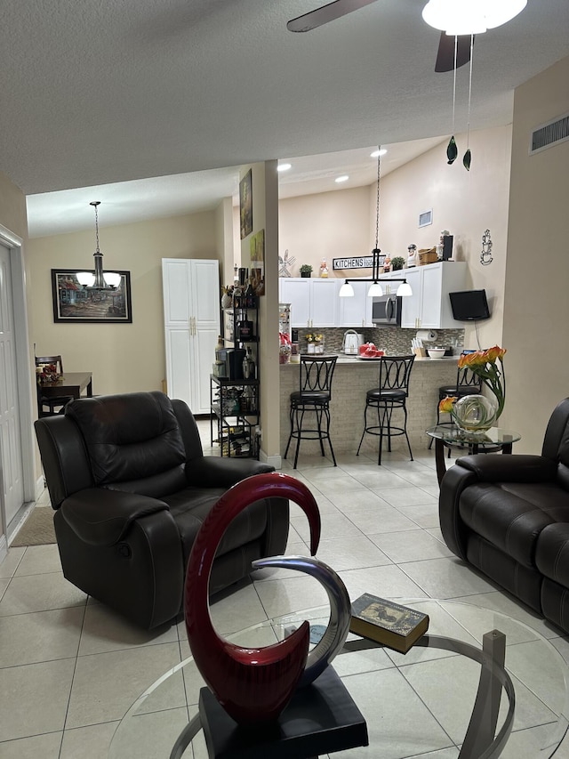 living area with visible vents and light tile patterned flooring