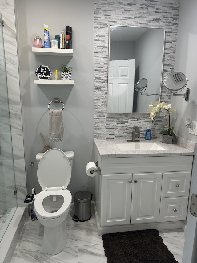 full bath featuring toilet, marble finish floor, tasteful backsplash, and vanity