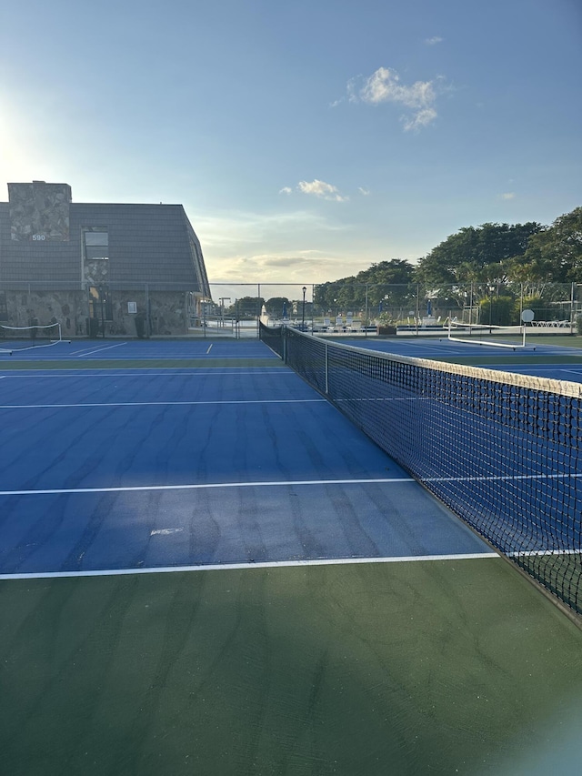 view of tennis court with fence