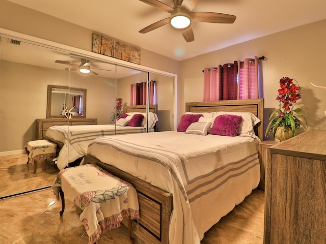 bedroom with ceiling fan and a closet