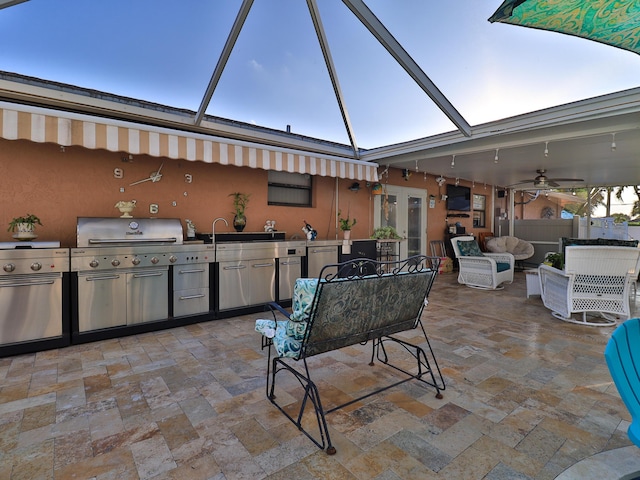 view of patio with a lanai and an outdoor kitchen