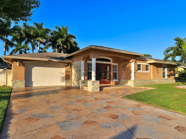 view of front of house featuring a garage, a front lawn, and french doors