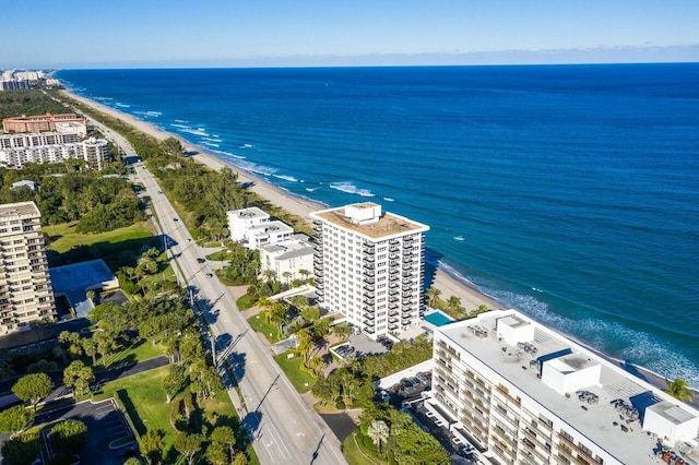 birds eye view of property featuring a water view and a beach view